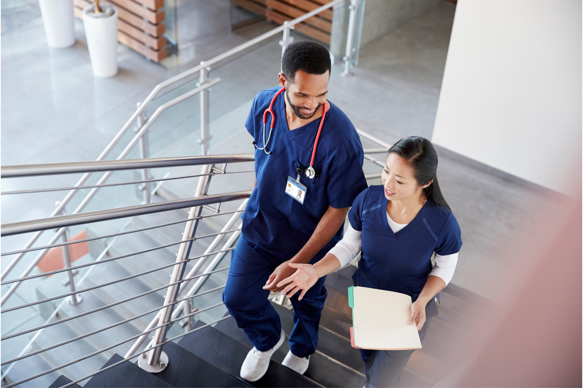 Medical professionals discussing patient care while walking through a hospital corridor